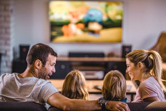 Family watching TV together